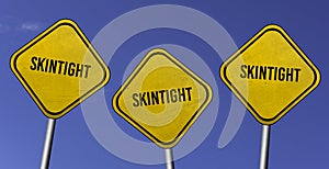 skintight - three yellow signs with blue sky background