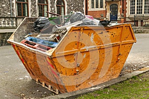 Skip container full of scrap waste household rubbish