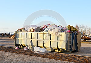Skip for dumping renovation waste. Metal tanks and capacities for storage and transportation of garbage. Metal trash