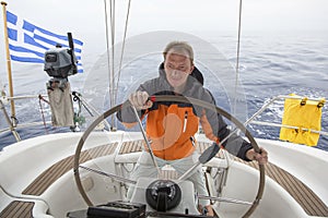 skipper drives the sailboat in the open sea. Yachting. Sailing.