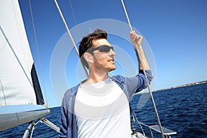 Skipper standing on sailing boat