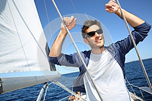Skipper standing on y sailing boat