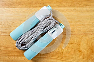 skipping rope with digital counters on wood background