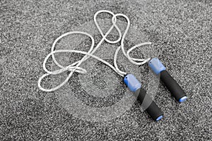 Skipping rope on grey background top view
