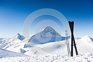 Skis in high mountains at sunny day