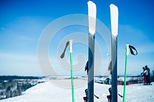Skis and poles sticking out of the snow, nobody