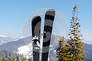 skis on snow hill mountain, winter alpine ski resort, extreme sport and winter mountain panoramic