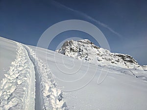 Skitour in deep snow in the Swiss Alps. View of the Sulzfluh mountain. Ski mountaineering. Skimo. High quality photo