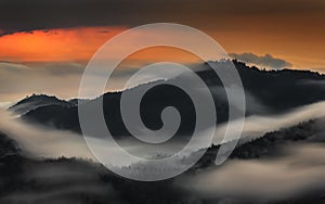 Skofja Loka, Slovenia - Long exposure panoramic shot of the mountains of Kranj region taken from Jamnik with summer morning fog photo