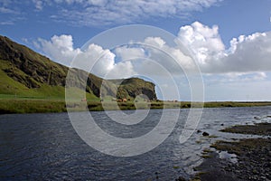 Skoga river and volcanic formation and outwash scenery near Skogafoss waterfall in Iceland