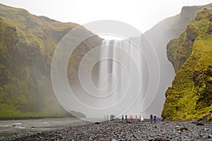 Skogafoss famous waterfall, Iceland and tourists