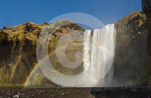 Skogafoss iceland waterfall with a rainbow and a beautiful sky in southern iceland