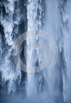 Skogafoss waterfall as a background. Natural icelandic background. Travelling on Iceland. Famouns place in Iceland.