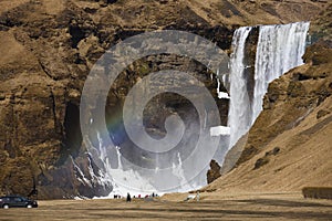 Skogafoss waterfall on iceland with a rainbow.