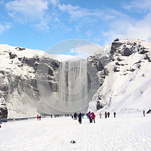 Skogafoss waterfall in Iceland with tourists