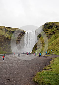 Skogafoss waterfall and tourists in the summer, Iceland