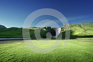 Skogarfoss waterfall and summer sunny day