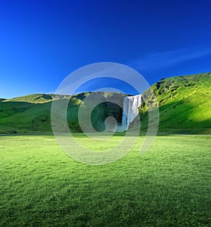 Skogarfoss waterfall and summer sunny day