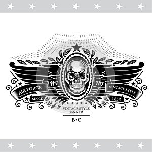 Skull front view with a lower jaw between pair wings and ribbons. Vintage label isolated