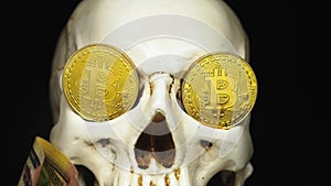 Skull with US Dollar bills in his mouth. bitcoins on the eyes.