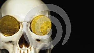 Skull with US Dollar bills in his mouth, bitcoins on the eyes. dark background