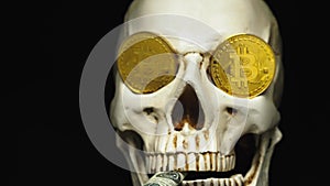 Skull with US Dollar bills in his mouth, bitcoins on the eyes. dark background