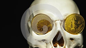 Skull with US Dollar bills in his mouth, bitcoins on the eyes. dark background