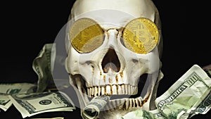 Skull with US Dollar bills in his mouth, bitcoins on the eyes. dark background