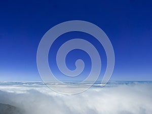 The infinite blue of the sky above the clouds of Madeira's heights. photo