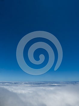 The infinite blue of the sky above the clouds of Madeira's heights. photo