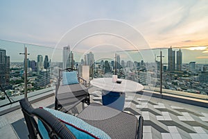 Sky bar, a restaurant or cafe lounge terrace with dinner table on rooftop of hotel, high rise architecture building with city view