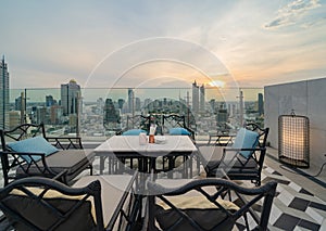 Sky bar, a restaurant or cafe lounge terrace with dinner table on rooftop of hotel, high rise architecture building with city view