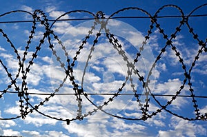 The sky behind the barbed wire