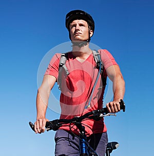 Sky, bike and man focus on cycling journey, sports workout or travel adventure for fitness, exercise or outdoor cardio