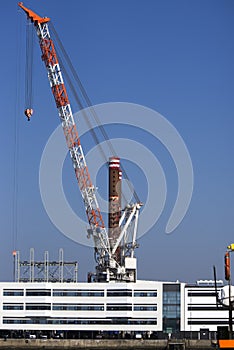 Sky blue large crane at Esbjerg harbor in Denmark.
