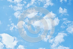 Sky. Blue sky with white clouds background. Curly clouds on a sunny summer day. Light cloudy. Good weather. Simple background sky