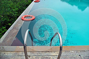 Sky blue water in infinity swimming pool at forest villa in india