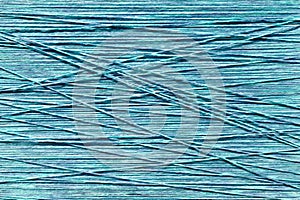 Sky blue yarn threads stretched on a loom abstract background