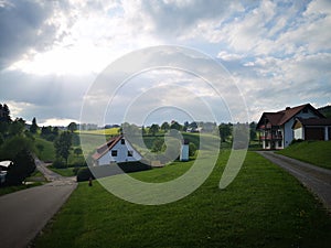 Sky and clouds in countryside, road and houses, germany