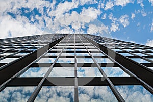 Sky and clouds reflection in windows of skyscraper