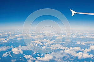 Sky and clouds seen from plane window. Atmosphere, stratosphere, air. Cloudscape, weather, nature. Wanderlust, adventure