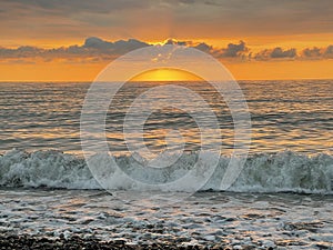 Sky, clouds, sun light and sea wave background. Bright sunset sky and ocean, abstract gold orange peaceful outdoors landscape
