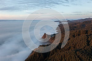 The sky is cloudy and the mountains are covered in trees