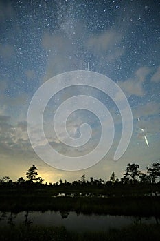 Night sky stars observingn over swamp in Latvia photo