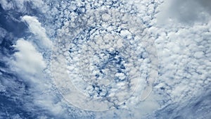 The clouds are fluffy and white against a backdrop of deep blue. photo