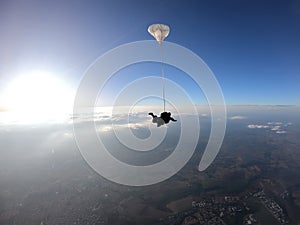 Sky dive tandem friends at the sunset