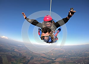 Sky dive tandem friends at the sunset