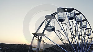 Sky, drone and ferris wheel for travel in city, lens flare and street view of amusement park for relax leisure. Cape