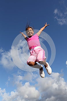 Sky is the limit jump for joy by young school girl