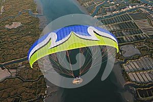 Sky man para-motor flying over the salt marshes on Charente-Maritime department , France